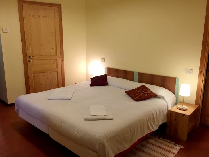 Bright room in a farmhouse, featuring essential furnishings and natural materials.