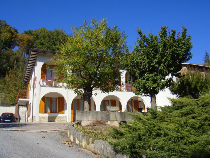 A villa surrounded by trees and gardens, perfect for a relaxing getaway in nature.