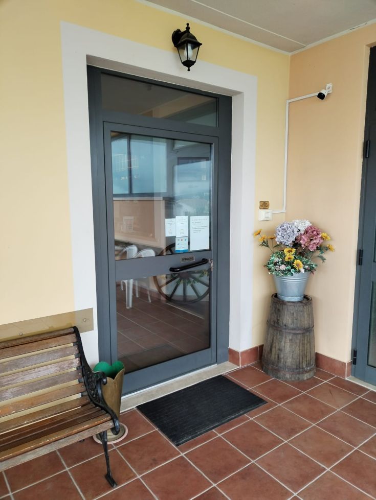 Entrance of the DUE STELLE Hotel, a cozy facility located in a rural area.