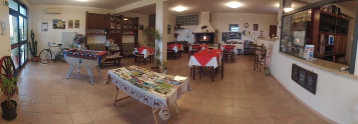 Simple interior of Hotel DUE STELLE featuring tables and spaces for guest relaxation.