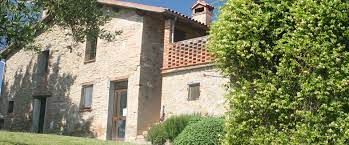 A stone farmhouse surrounded by green hills, perfect for a nature getaway.