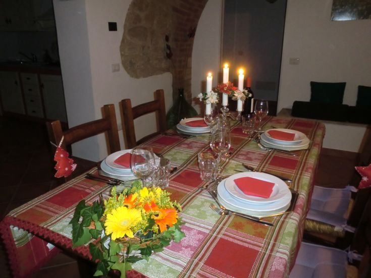 An elegantly set table with candles and flowers, perfect for a romantic dinner.