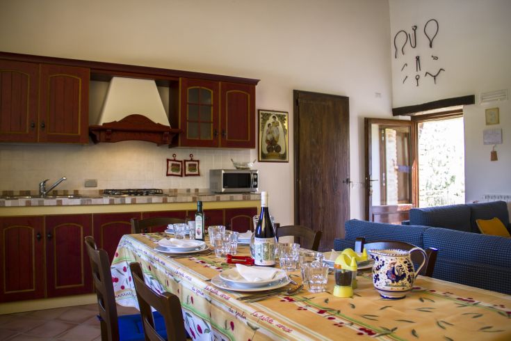 A family-friendly kitchen with a set table and typical local dishes.