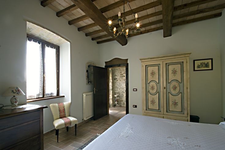 Camera confortevole con arredi in stile rustico e panorama sul giardino.