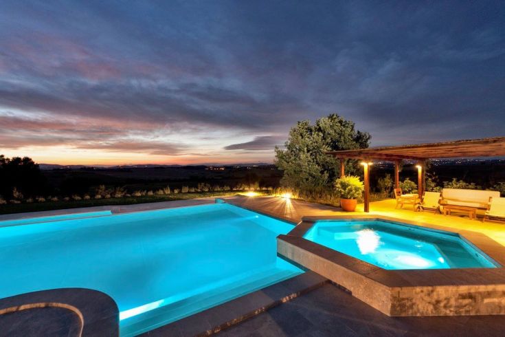 A pool nestled in nature, bathed in the warm light of sunset.