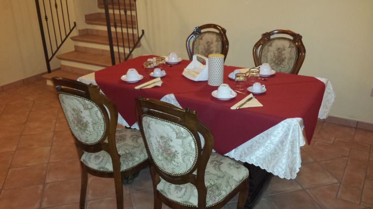 A meticulously set table with coordinated chairs, ready for an elegant dinner.