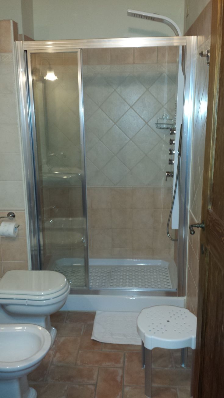 Modern bathroom furnished with a shower and practical amenities, perfect for a comfortable stay.