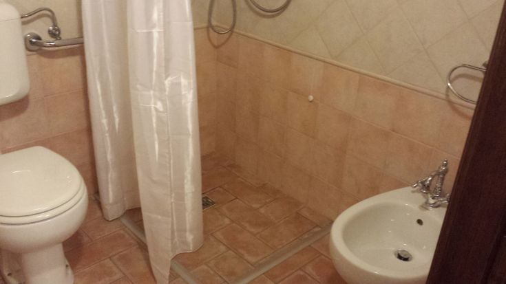 Bright bathroom with shower, sink, and toilet. Well-organized and practical for daily use.