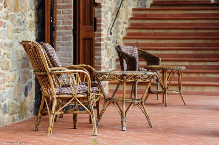 A comfortable area with rattan furniture, perfect for relaxing and enjoying the surrounding environment.