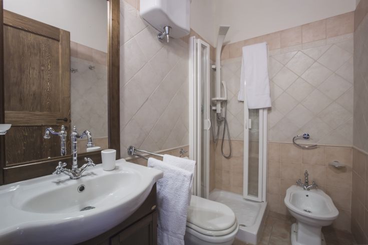 Functional bathroom with a shower, sink, and simple finishes.