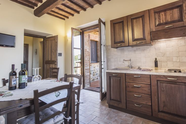 Rustic wooden kitchen overlooking a garden, perfect for tranquil moments with family.