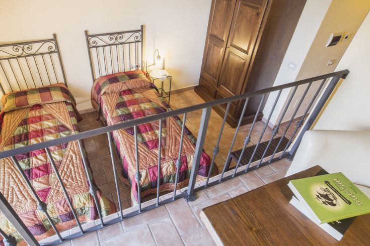 Cozy room with single beds, wooden wardrobe, and a peaceful atmosphere.