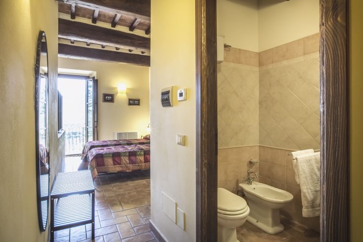 Cozy room with a private bathroom and rustic style details.