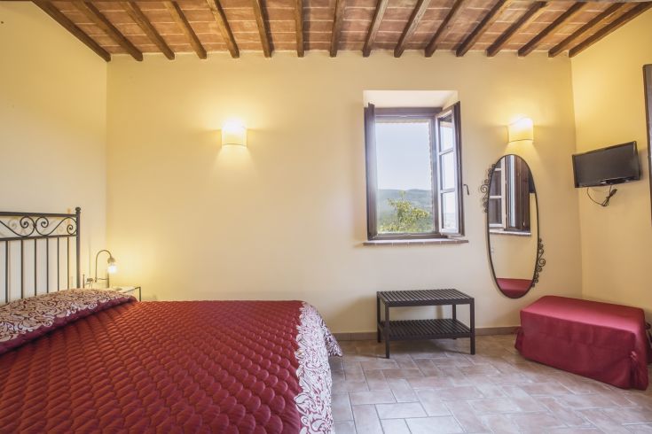 A cozy room with a view, simple furnishings, and warm tones, perfect for a relaxing stay.