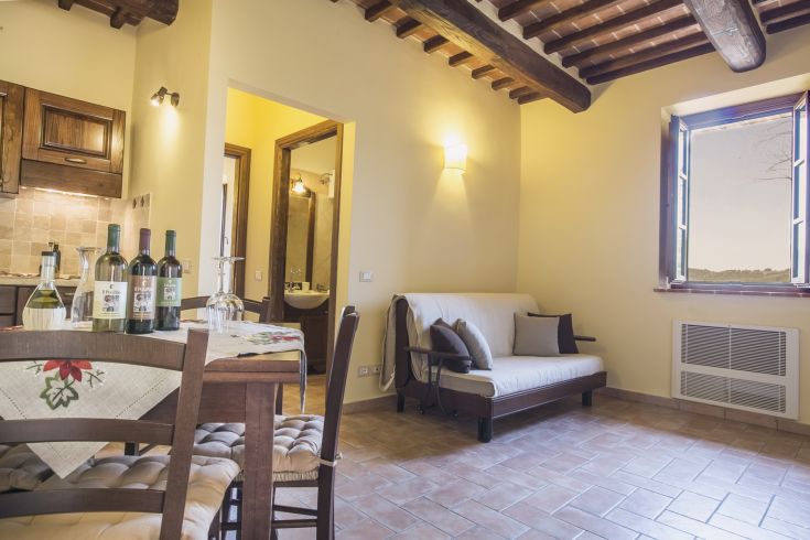 A cozy apartment with a rustic-style kitchen and living room, surrounded by Umbrian nature.