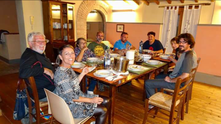 A group of friends spends the evening around a nicely set table in a cozy atmosphere.