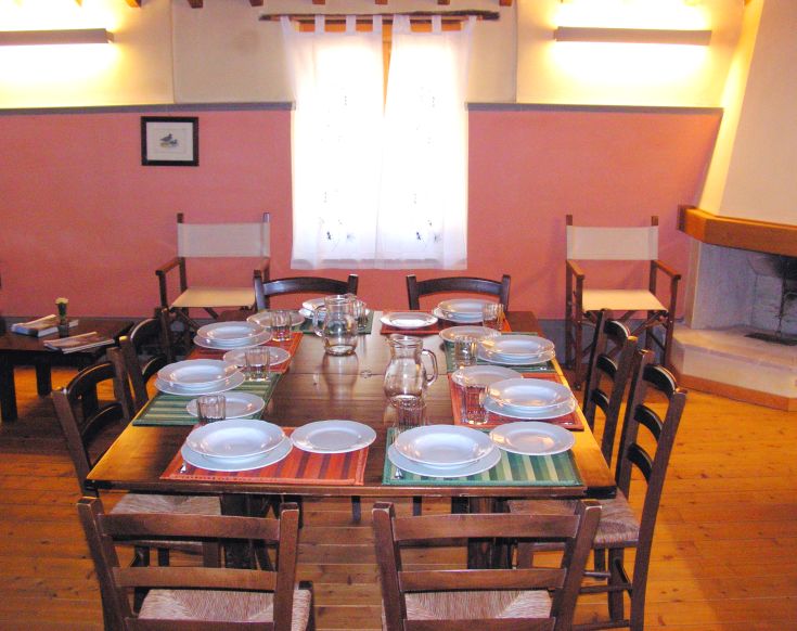 A spacious and bright dining room with a simply set table, perfect for sharing meals.