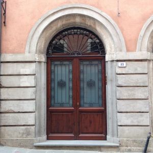 Wooden door with iron details, located in the center of an Umbrian town.