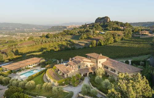 A nature-surrounded resort in Umbria featuring a spa, pools, and comfortable rooms for a relaxing experience.