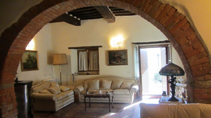 Soggiorno luminoso in un palazzo umbro, caratterizzato da un'atmosfera accogliente.