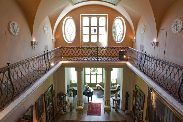 Intérieurs d'un bâtiment historique avec des détails architecturaux typiques et vue sur la campagne ombrienne.