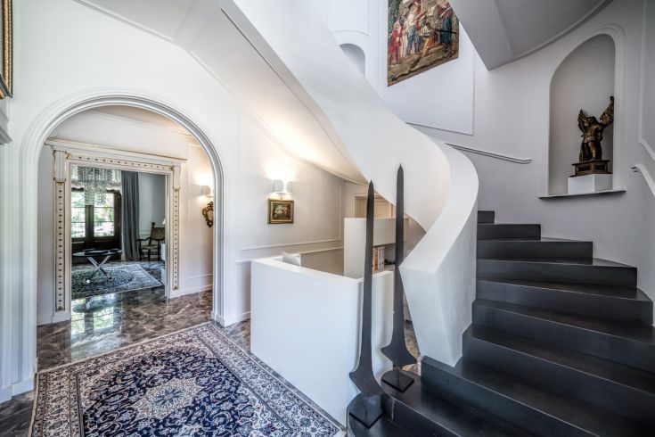 Interno di un palazzo con scale semplici e dettagli architettonici essenziali.