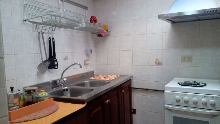 Una cucina spaziosa e ben illuminata, dotata degli strumenti necessari per cucinare facilmente.