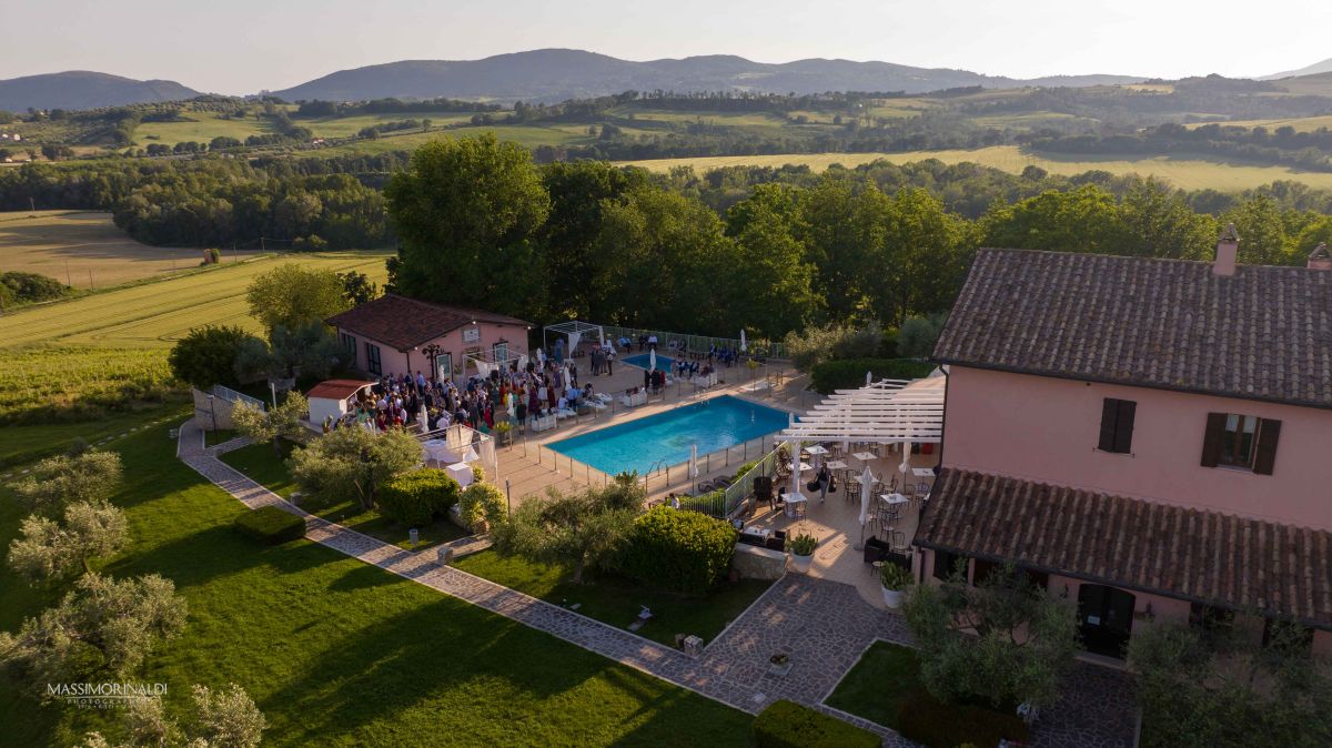 Angolo di una tenuta con piscina, circondata dalla vegetazione tipica dell'Umbria, adatta per eventi e momenti di relax.
