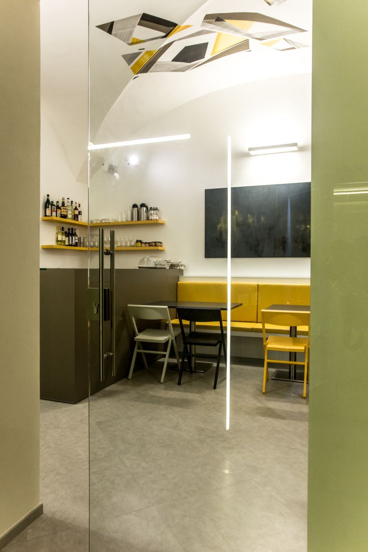 Interior of a modern restaurant with well-equipped tables and bar counter. Cozy atmosphere and simple design.