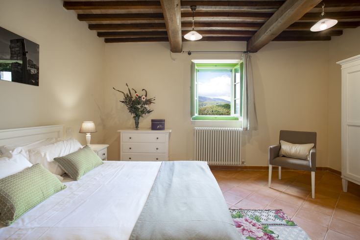 Simple room with minimal furniture and a view of the surrounding nature.
