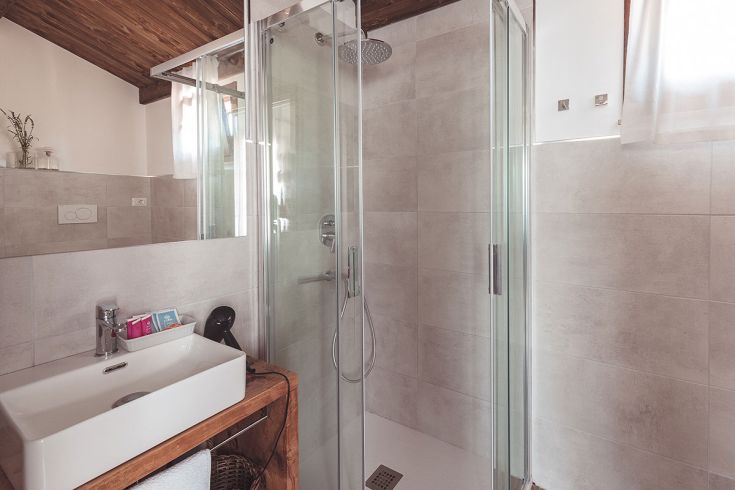 Bagno ben arredato con doccia e sanitari, perfetto per un soggiorno confortevole.