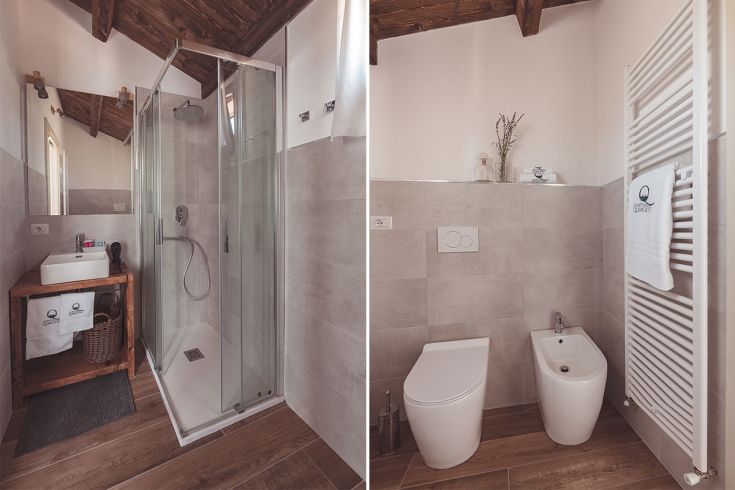 Un bagno contemporaneo con doccia in vetro e arredi semplici, ideale per un ambiente rilassante.