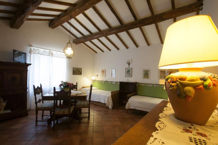 Cozy room with exposed beams, rustic furnishings, and great natural light.