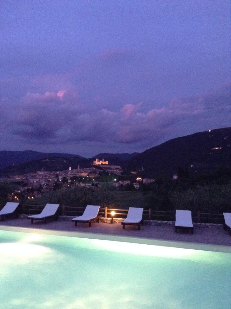 Calm sunset over Spoleto with a visible pool in the foreground.