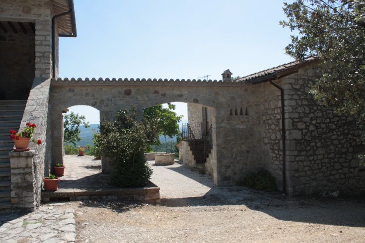 View of the Umbrian hills from a countryside agriturismo surrounded by nature.