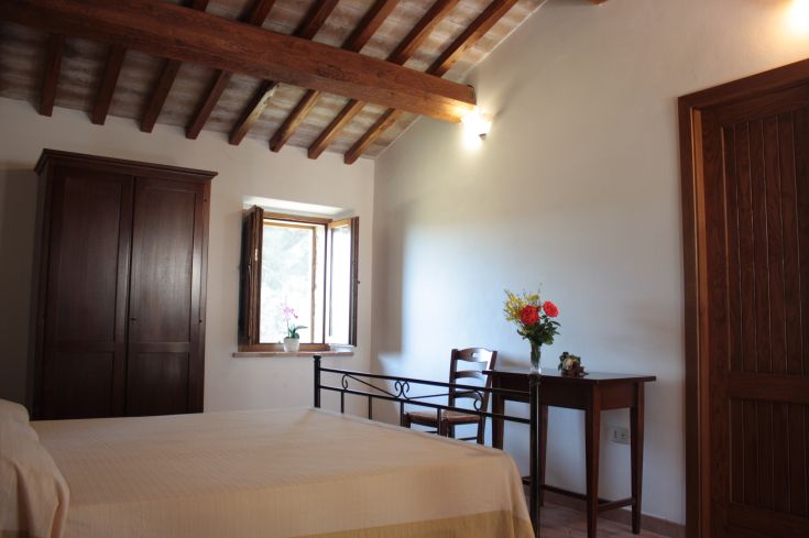 Simple room with rustic elements and a view of a natural landscape.