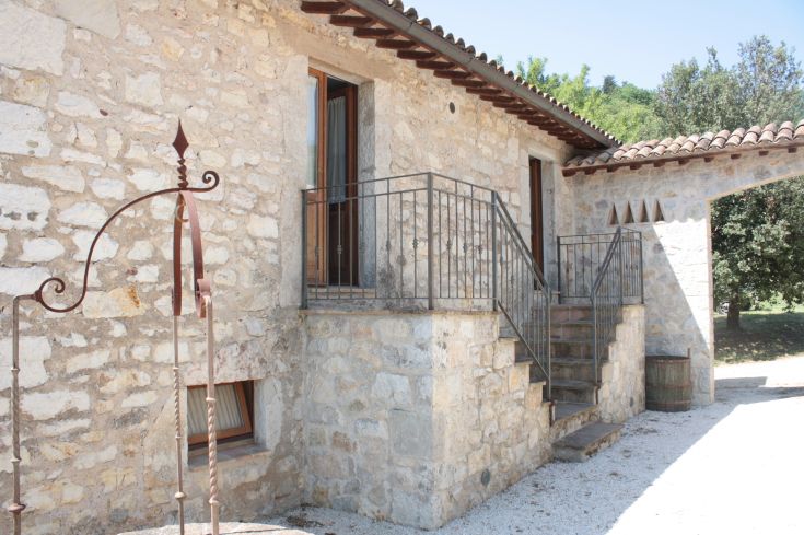 A stone building with rustic details, surrounded by greenery, perfect for relaxing moments in nature.
