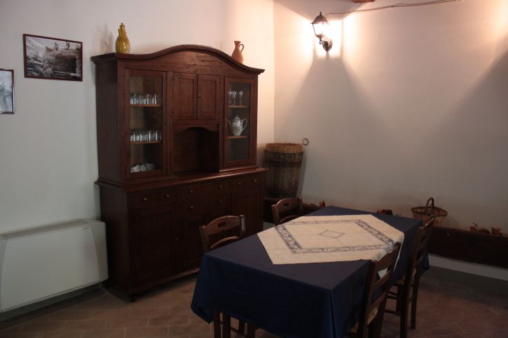 A charming area of a farmhouse, featuring simple furnishings and a welcoming atmosphere.