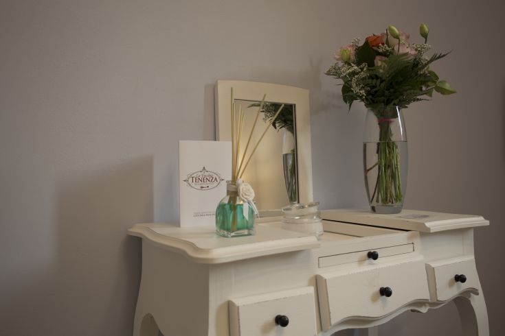 A table adorned with fresh flowers and a diffuser in a cozy setting.
