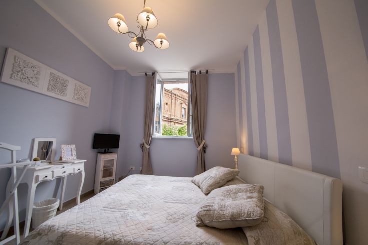 Cozy room with shabby chic decor and a view of the Medieval Fortress.