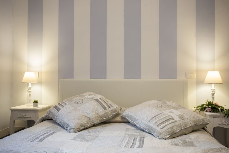 Spacious room in a B&B, featuring simple furnishings and shabby chic decorations.