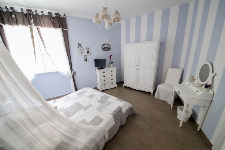 Simple shabby chic room furnished with functional decorations and charming furnishings.