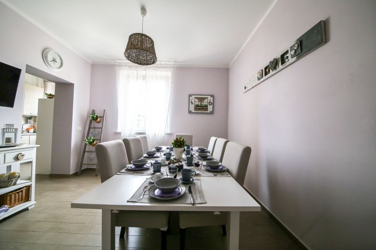 Cozy kitchen space with wooden furniture and light tones, perfect for family moments.