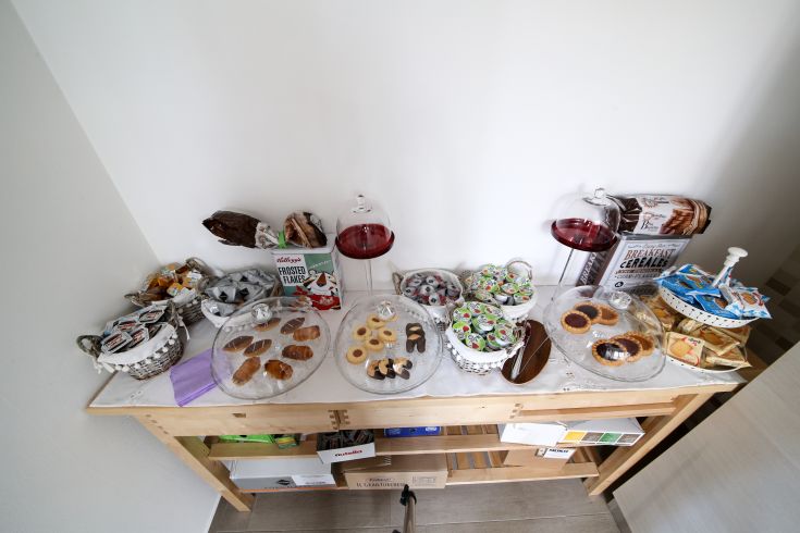A tempting array of pastries, cookies, and cereals on a buffet showcasing a simple but delightful breakfast.