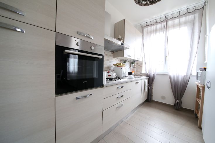 Modern and functional shabby chic kitchen, featuring natural lighting and understated details.
