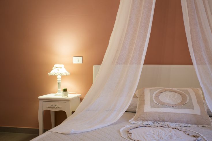 A cozy room decorated in shabby chic style with warm lighting.