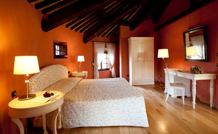 Room with orange walls and wooden beam ceiling, perfect for relaxing moments.