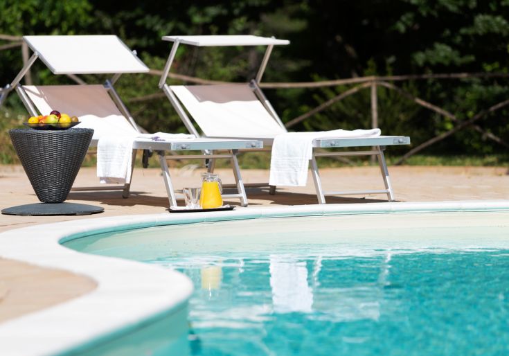 Relaxation by the pool, surrounded by nature. A perfect place to unwind and recharge.