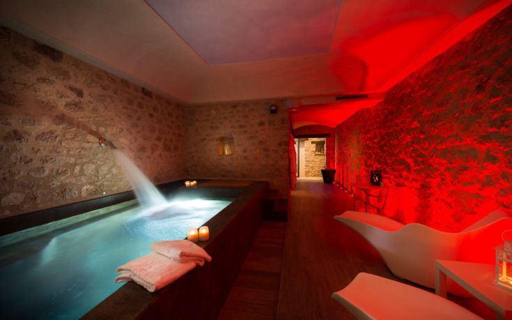 Innenraum eines Gebäudes mit beleuchtetem Pool und entspannender Atmosphäre.