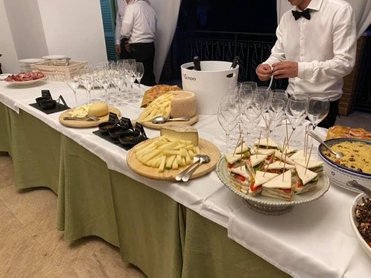A simple buffet featuring a variety of cheeses, cold cuts, and snacks.